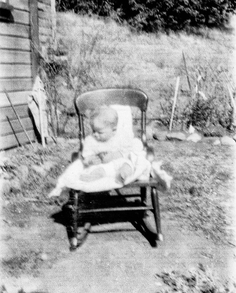 1928-07c-Angie-in-rocking-chair-on-Spaulding-farm-near-Frutiland.jpg