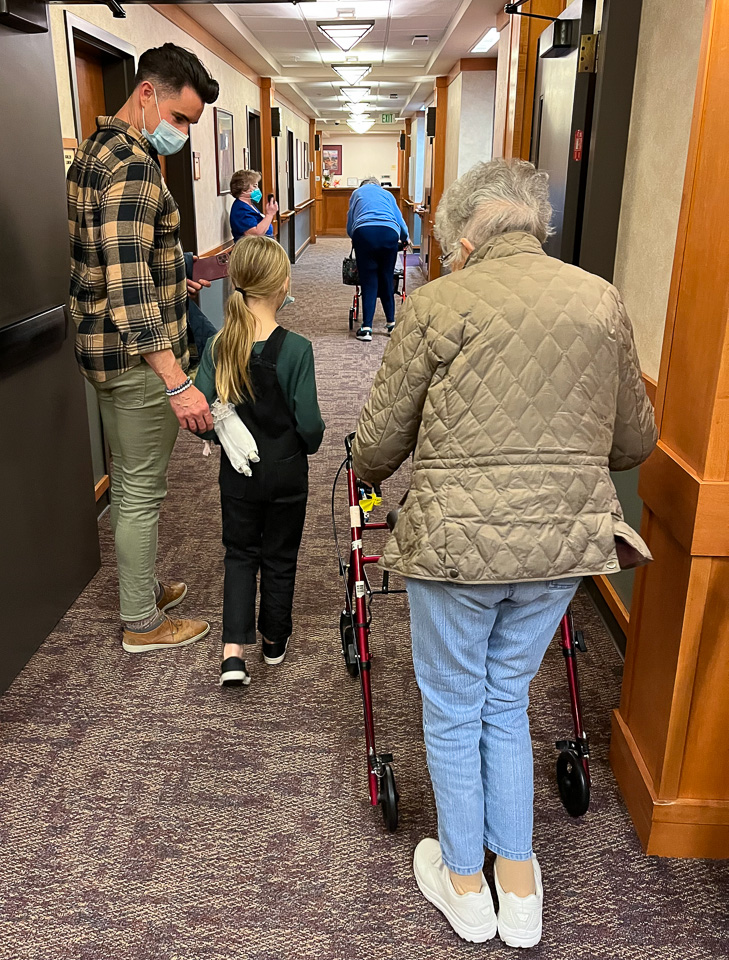 2022-10-24-2-Angie-navigates-the-hallway-with-Conrad-and-Charlie.jpg